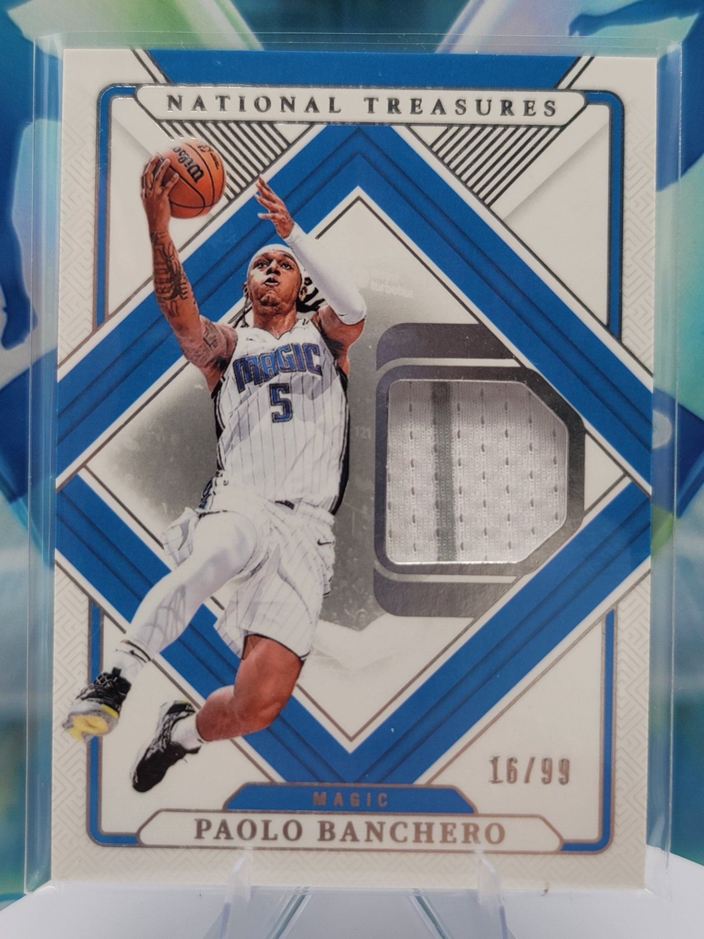 2025 Panini National Treasures Paolo Banchero — 2025 Panini National Treasures Patch Paolo Banchero #16 of 99 Patch/Memorabilia